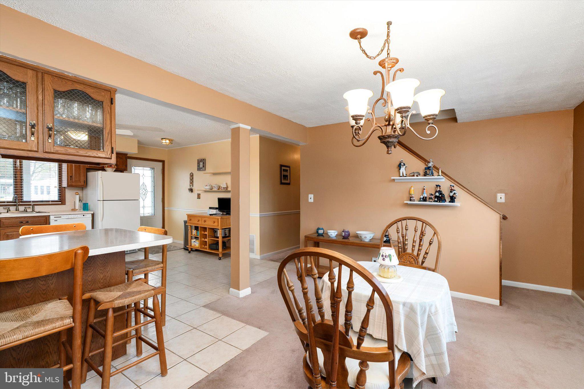 24 Cumberland Road Hamilton, NJ 08690 - Photo 10 of 29 a view of a dining room with furniture and a chandelier