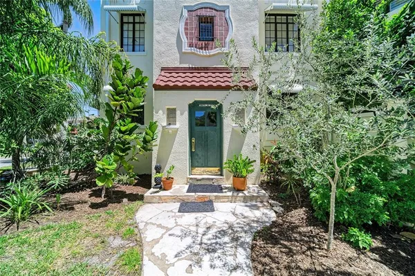 front view of a house with potted plants