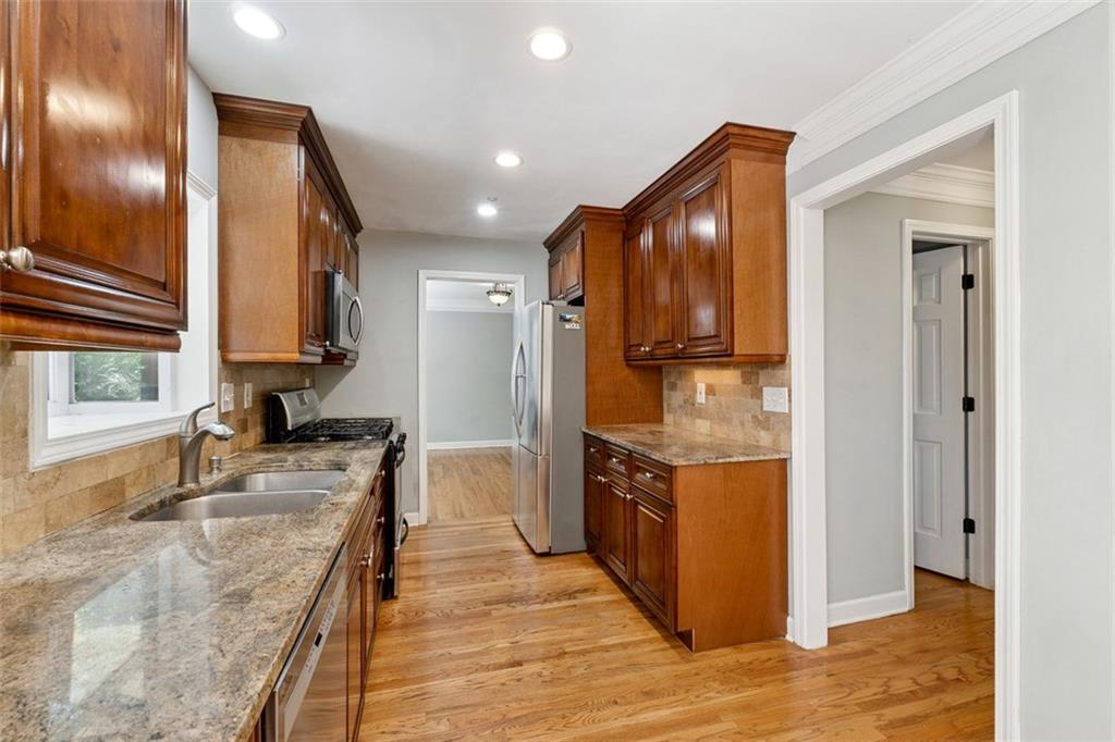 3675 Toxaway Court Chamblee, GA 30341 - Photo 11 of 37 a kitchen with stainless steel appliances granite countertop a stove and a refrigerator