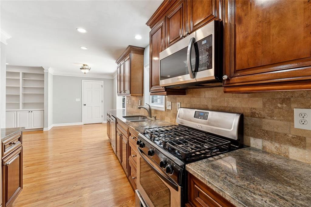 3675 Toxaway Court Chamblee, GA 30341 - Photo 12 of 37 a kitchen with stainless steel appliances granite countertop a stove and a microwave