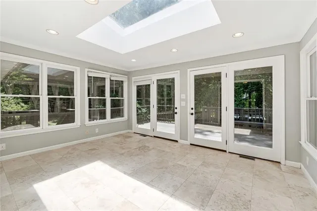 a view of a large window with plants in front of main door