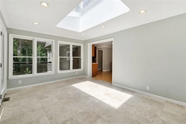 an empty room with large windows