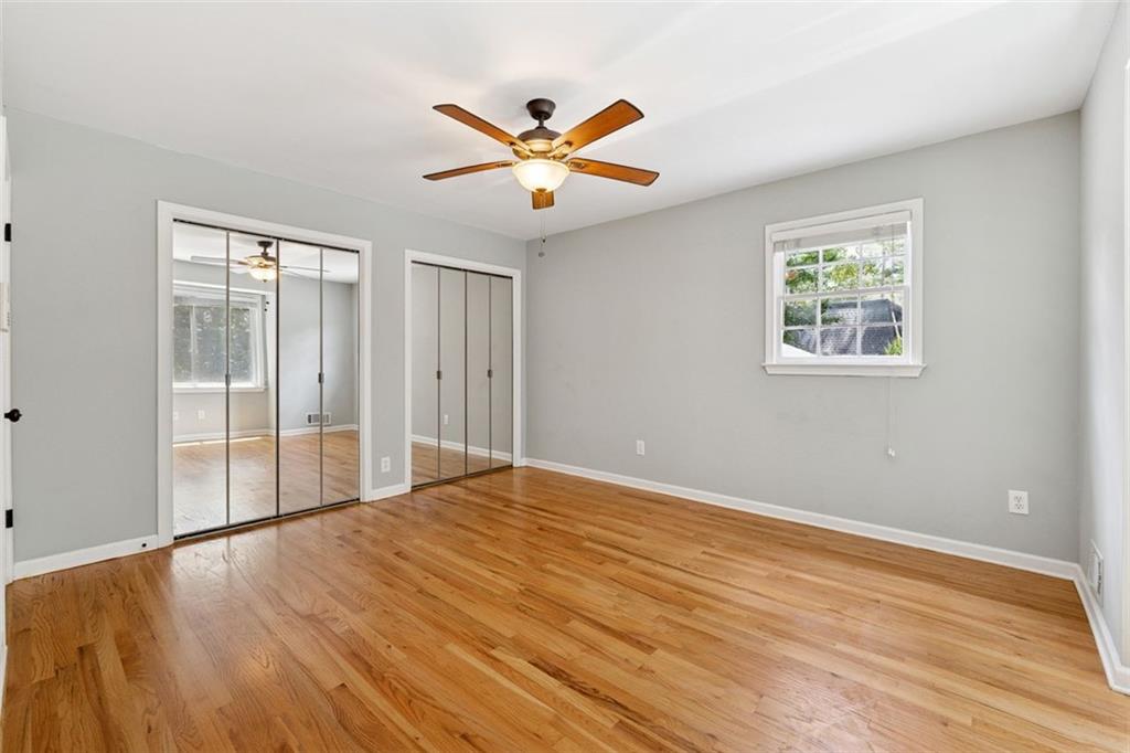3675 Toxaway Court Chamblee, GA 30341 - Photo 19 of 37 an empty room with wooden floor fan and windows