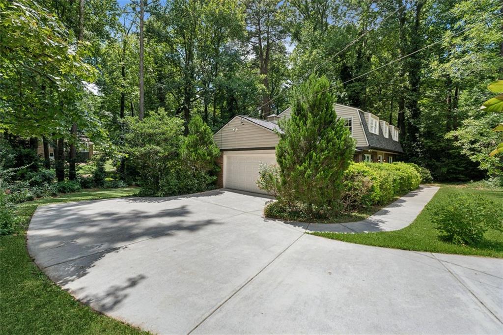 3675 Toxaway Court Chamblee, GA 30341 - Photo 5 of 37 a front view of a house with a yard and garage