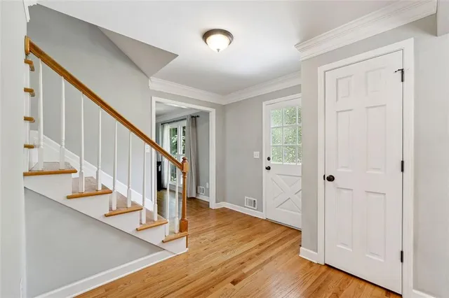 a view of entryway with wooden floor and stairs