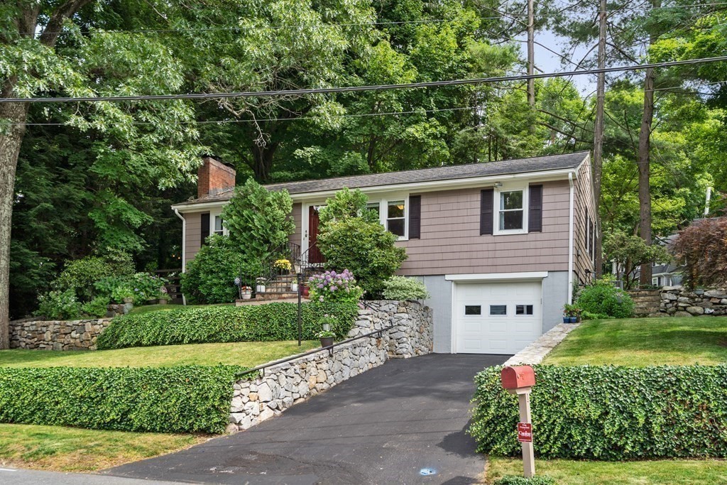 1 Bow Street Wellesley, MA 02481 - Photo 1 of 37 a front view of a house with a yard and a garden