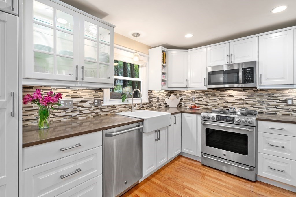 1 Bow Street Wellesley, MA 02481 - Photo 11 of 37 a kitchen with stainless steel appliances kitchen island granite countertop a stove sink and microwave