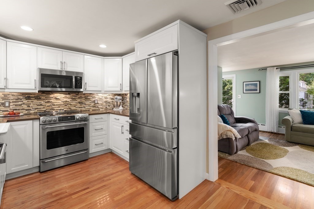 1 Bow Street Wellesley, MA 02481 - Photo 12 of 37 a kitchen with a refrigerator stove and wooden cabinets
