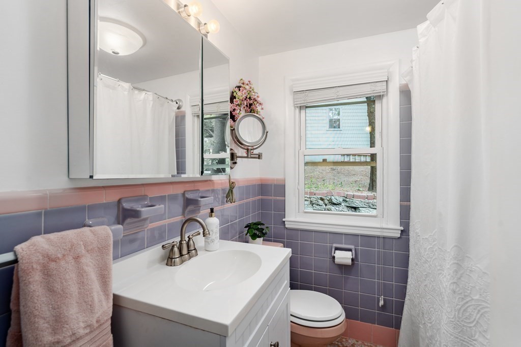 1 Bow Street Wellesley, MA 02481 - Photo 20 of 37 a bathroom with a sink a toilet and a mirror