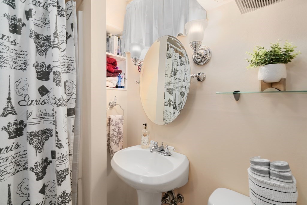 1 Bow Street Wellesley, MA 02481 - Photo 24 of 37 a bathroom with a sink and mirror with toilet