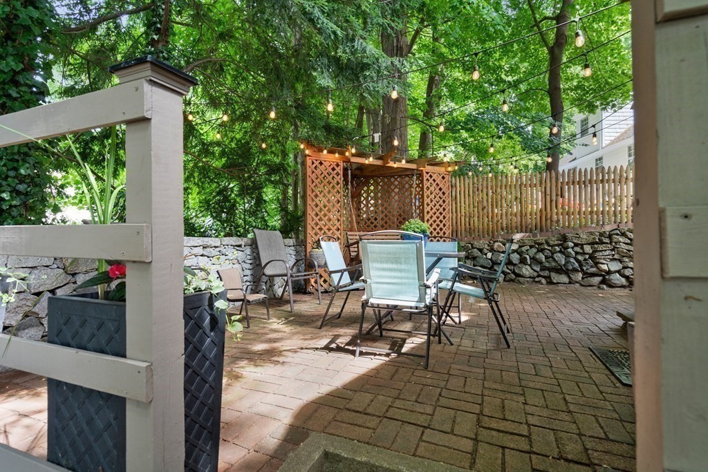 1 Bow Street Wellesley, MA 02481 - Photo 33 of 37 a view of a patio with table and chairs and potted plants