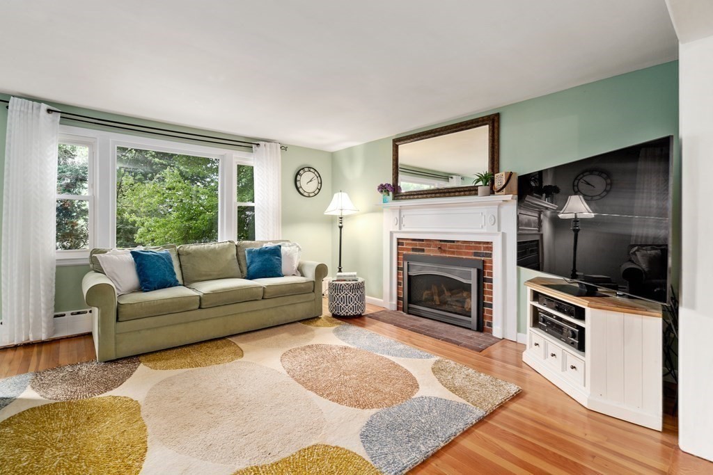 1 Bow Street Wellesley, MA 02481 - Photo 5 of 37 a living room with furniture a flat screen tv and a fireplace