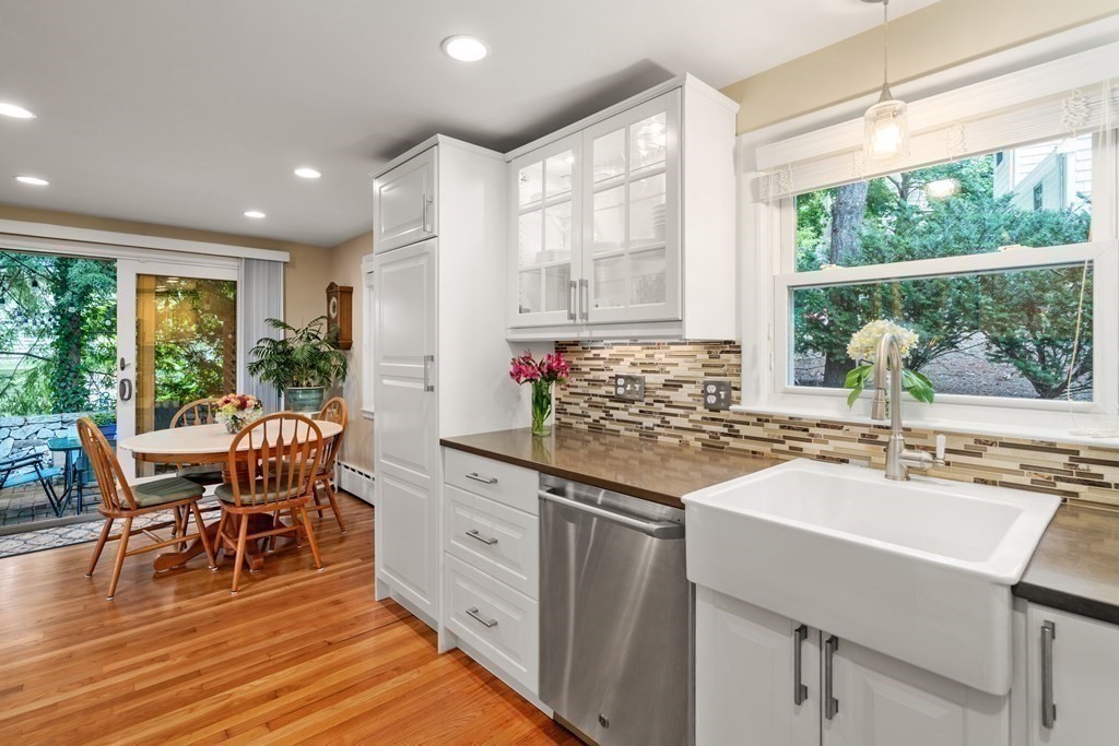 1 Bow Street Wellesley, MA 02481 - Photo 10 of 37 a kitchen with stainless steel appliances granite countertop sink stove and wooden cabinets
