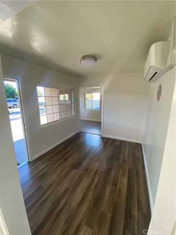 a view of an empty room and wooden floor