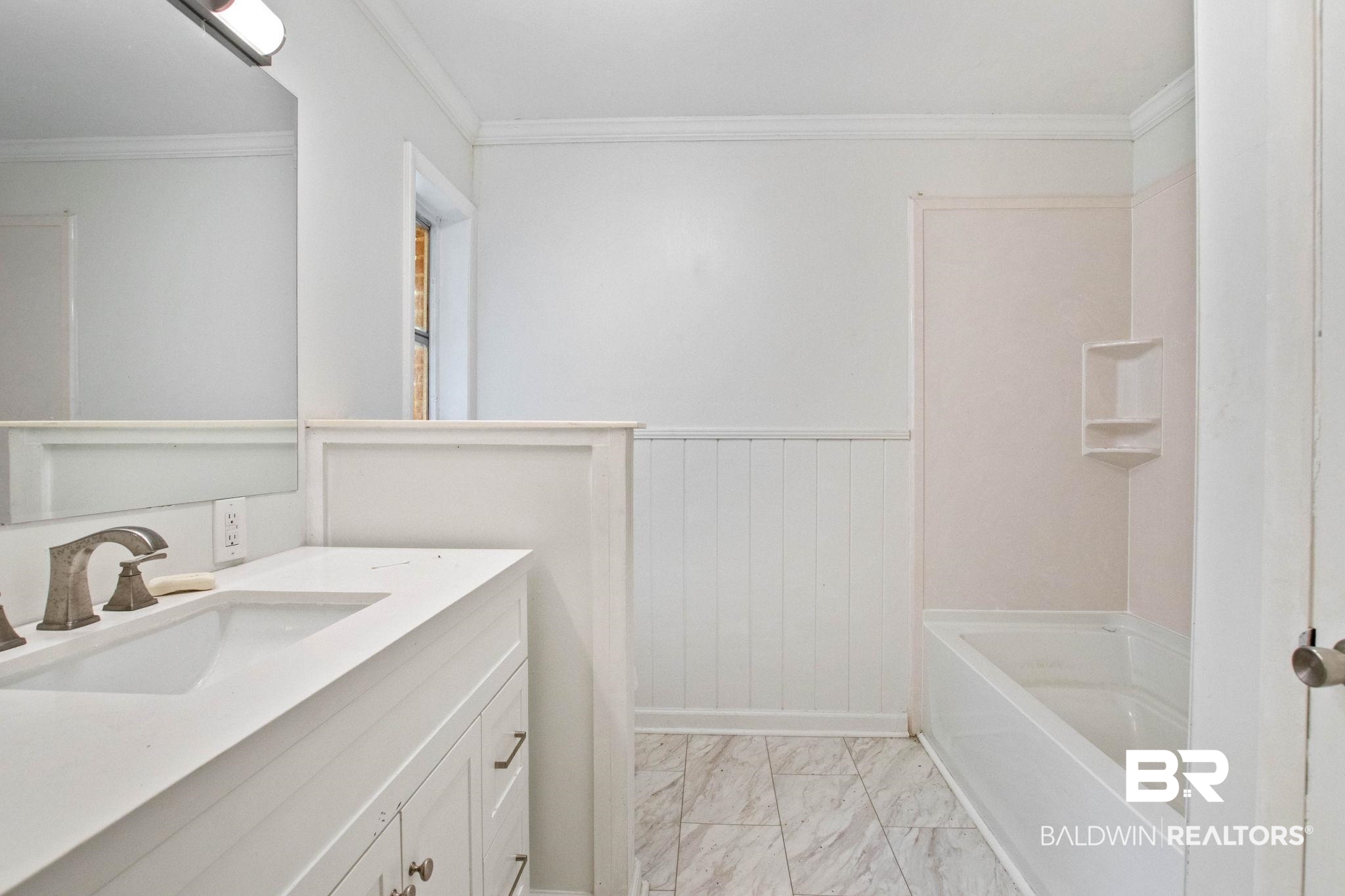 384 Old Bratt Road Atmore, AL 36502 - Photo 48 of 64 Bathroom featuring a white vanity with a single basin sink, brushed nickel faucet, and a large mirror