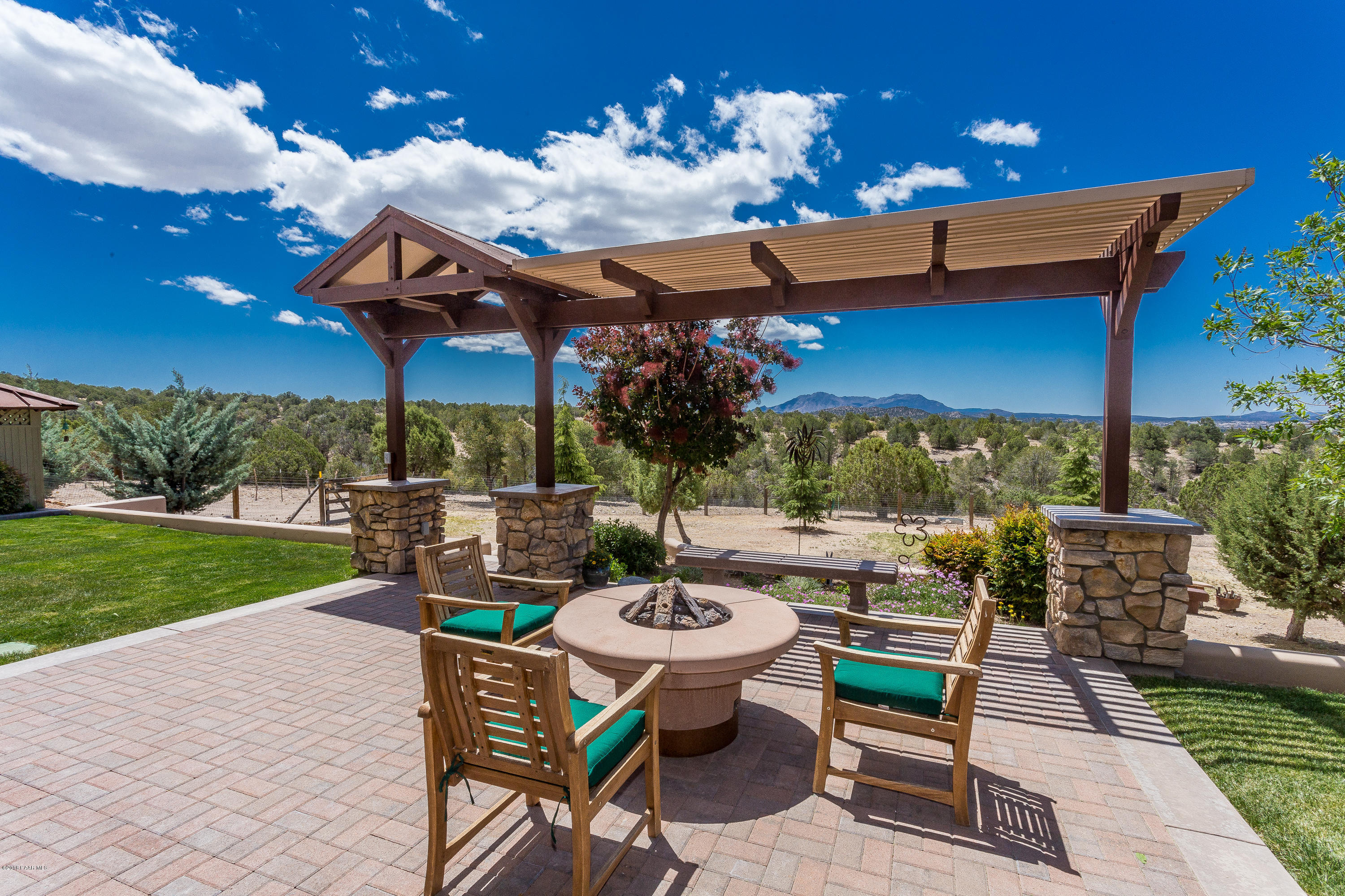 18401 Crossroads Ranch Road Prescott, AZ 86305 - Photo 30 of 51 a view of a patio with a table chairs and a fire pit