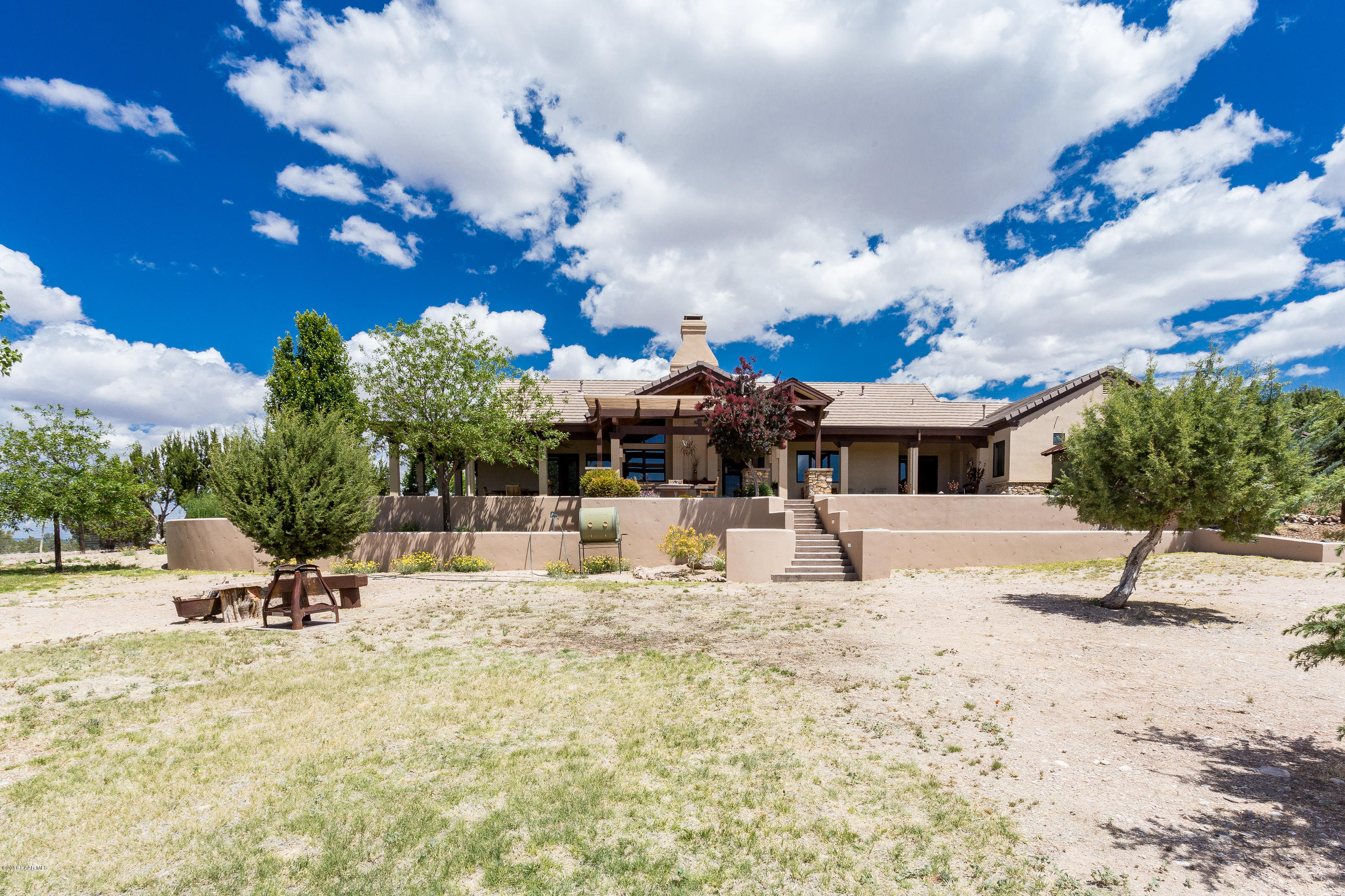 18401 Crossroads Ranch Road Prescott, AZ 86305 - Photo 36 of 51 a view of a house with a yard and sitting area