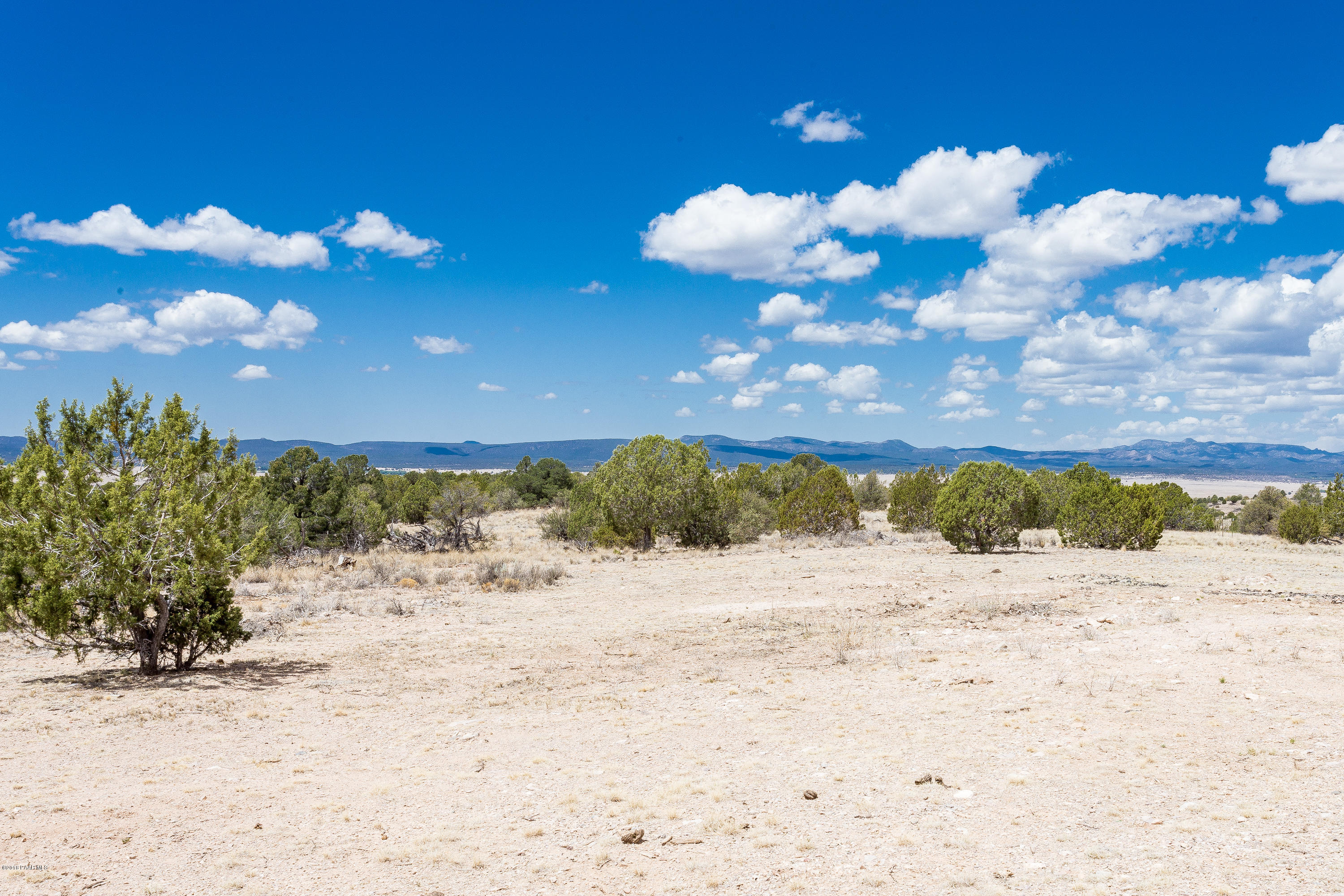 18401 Crossroads Ranch Road Prescott, AZ 86305 - Photo 47 of 51 a view of a beach with sunset