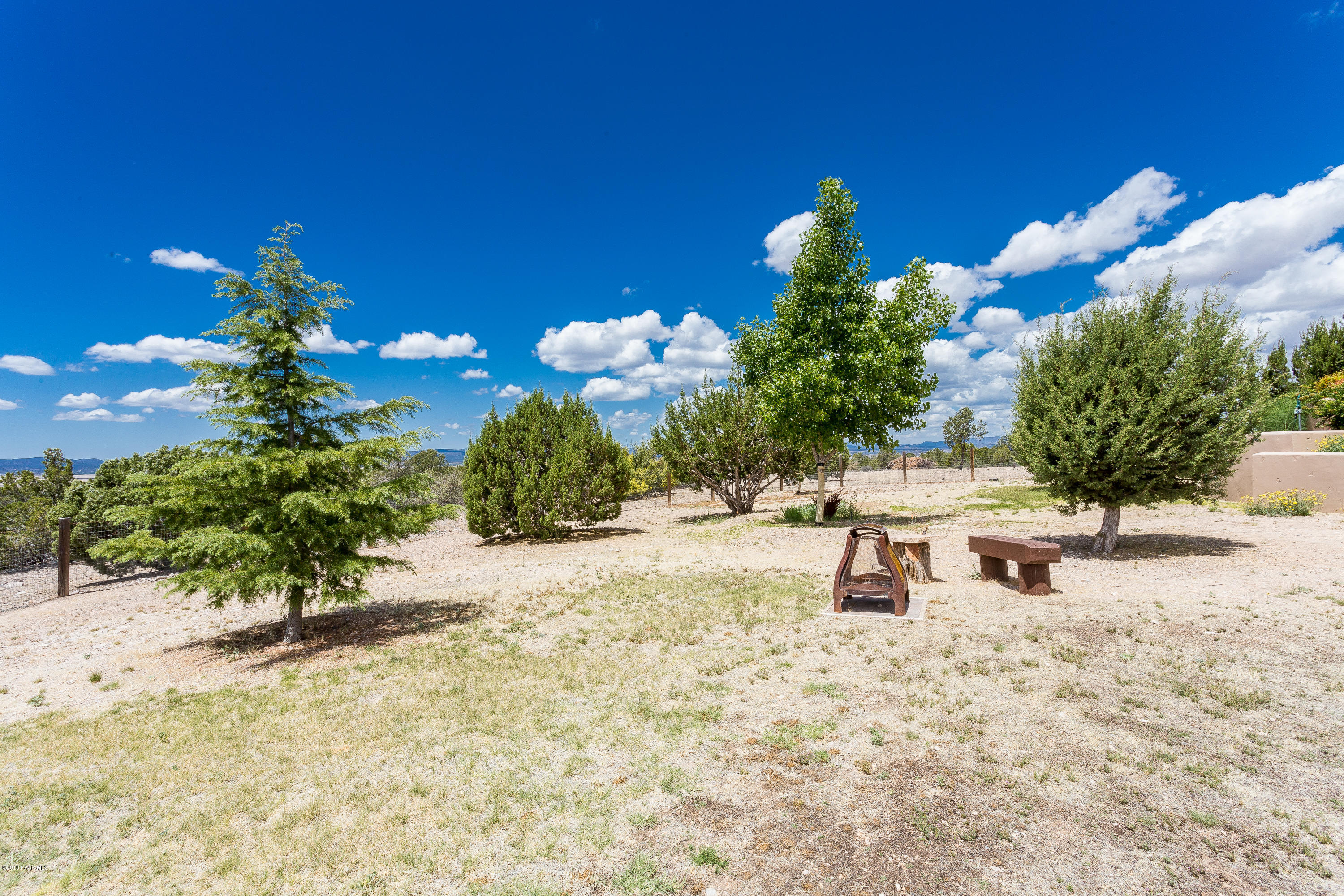18401 Crossroads Ranch Road Prescott, AZ 86305 - Photo 49 of 51 a wooden bench sitting in the middle of a yard