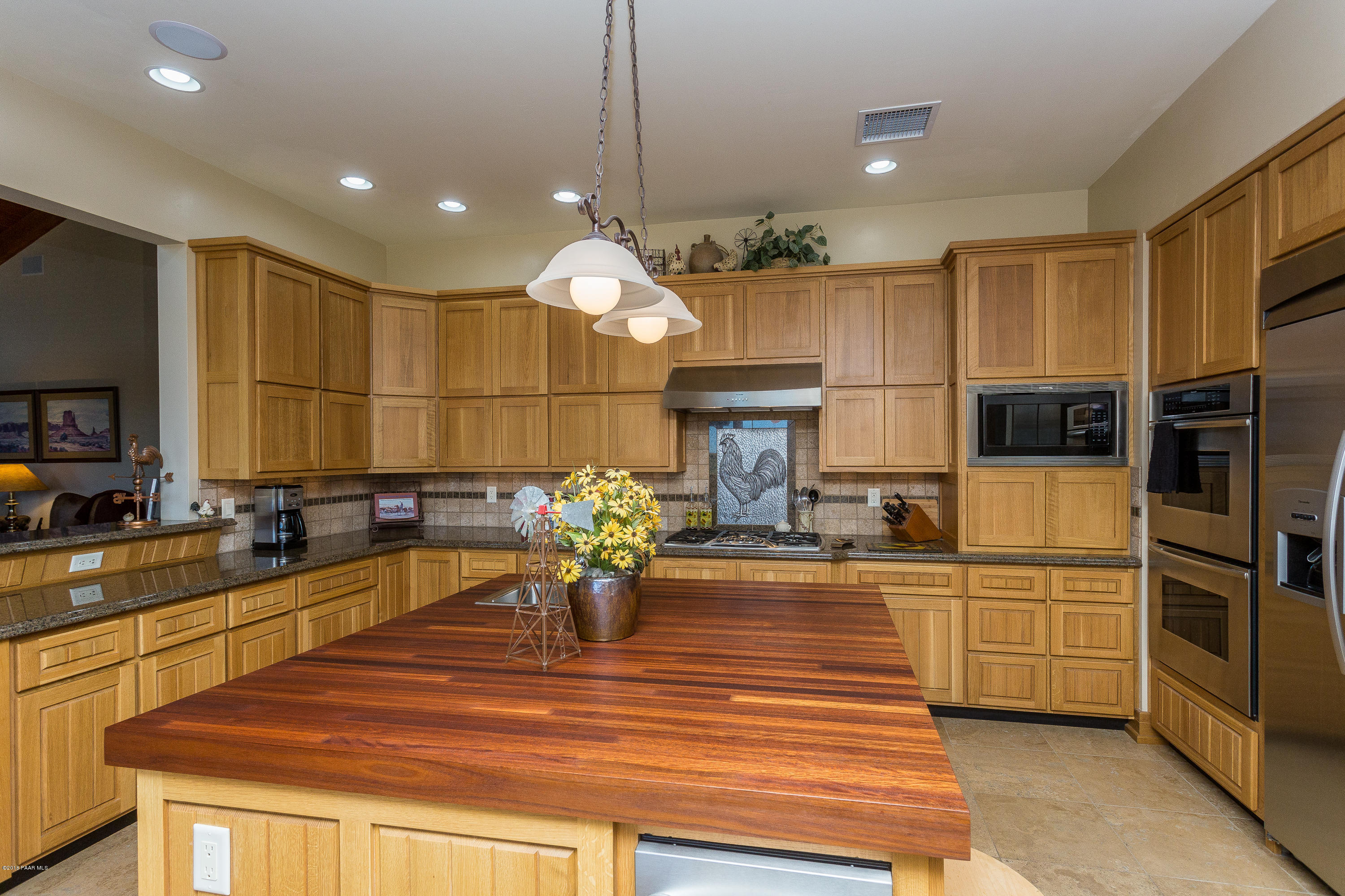 18401 Crossroads Ranch Road Prescott, AZ 86305 - Photo 10 of 51 a kitchen with stainless steel appliances kitchen island granite countertop a sink and cabinets