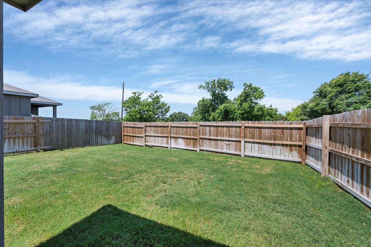 1202 Garland Road Georgetown, TX 78626 - Photo 7 of 28 Expansive backyard featuring a lush lawn and a perimeter wood privacy fence
