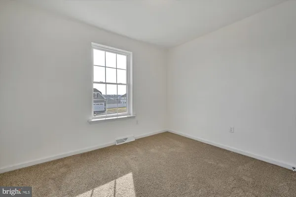 a bedroom with furniture and window
