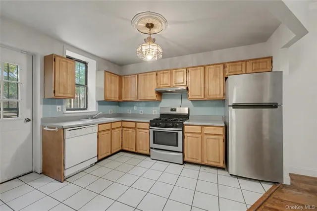 a kitchen with granite countertop stainless steel appliances a refrigerator a sink a stove a microwave and cabinets