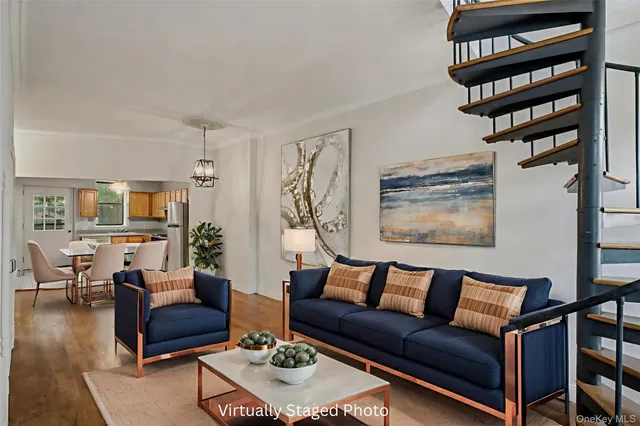a living room with furniture a rug and a window