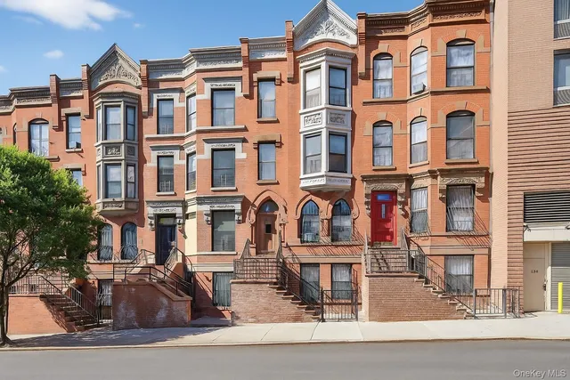 a front view of a residential apartment building with a yard