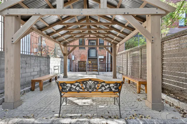 a patio with glass top table and chairs