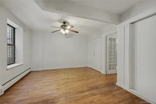 wooden floor in an empty room with a window