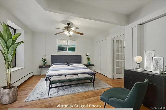 a spacious bedroom with a bed a couch and a potted plant