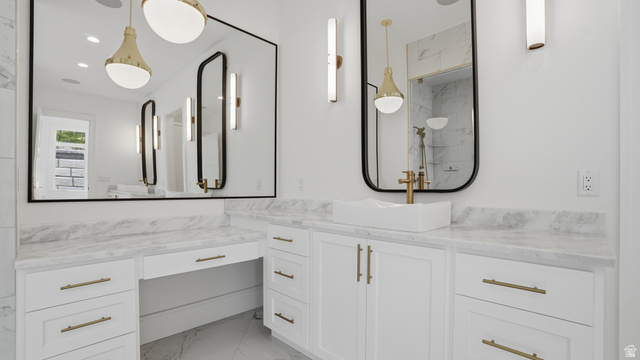 1682 North 1950 W Street, Unit 9 Provo, UT 84604 - Photo 33 of 84 Bathroom vanity featuring white cabinetry with brass hardware, a contrasting white vessel sink, and a large wall-mounted mirror