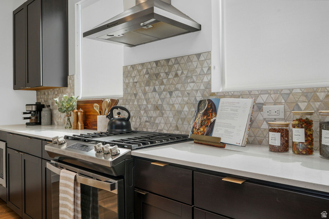 493 East Alice Way Layton, UT 84041 - Photo 5 of 31 Kitchen with gas stove, island range hood, and light stone countertops
