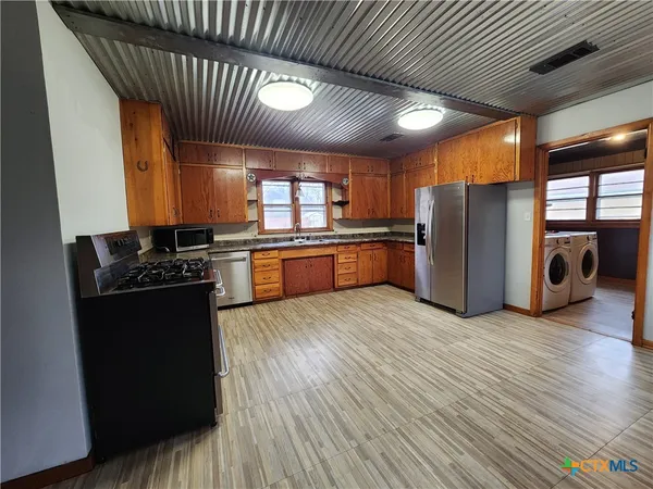 a room with wooden floor and sink