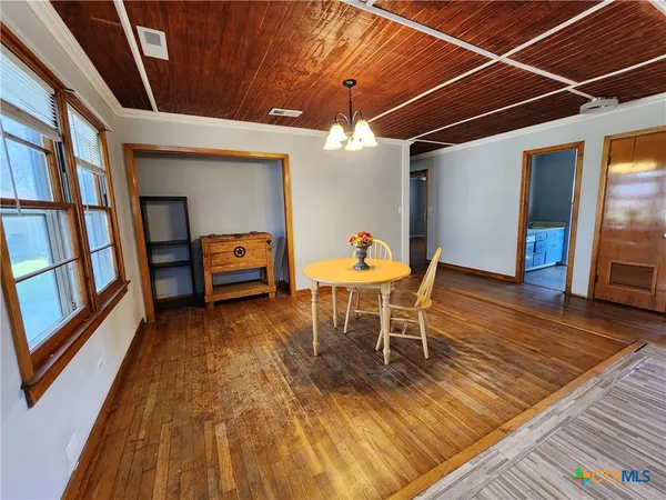 a room with wooden furniture and gym equipment