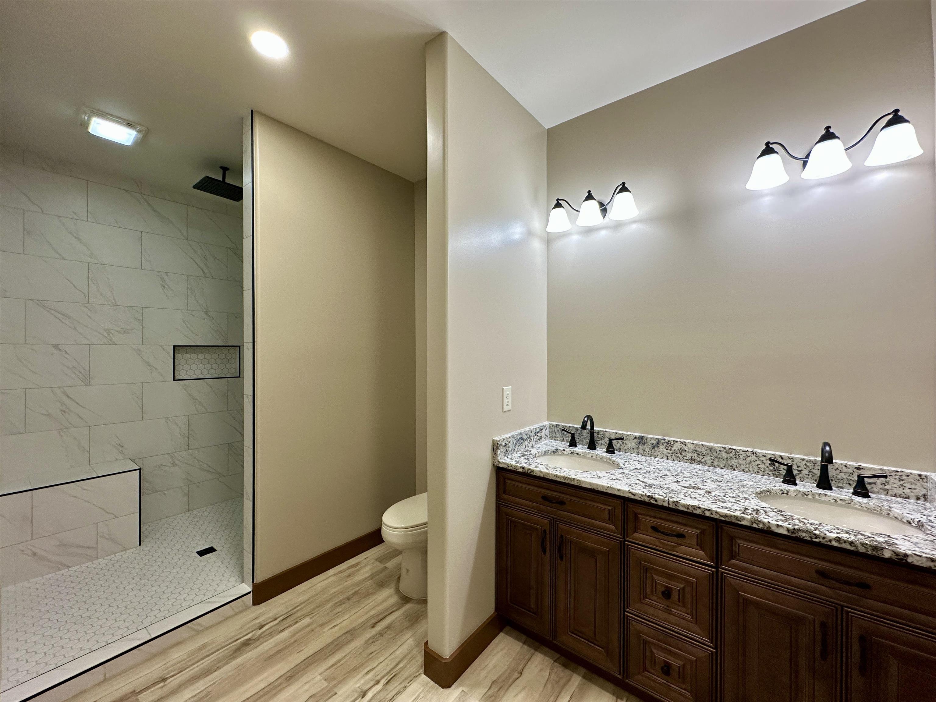 1137 Arl Bailey Road Finger, TN 38334 - Photo 13 of 40 a spacious bathroom with a granite countertop sink a toilet and shower