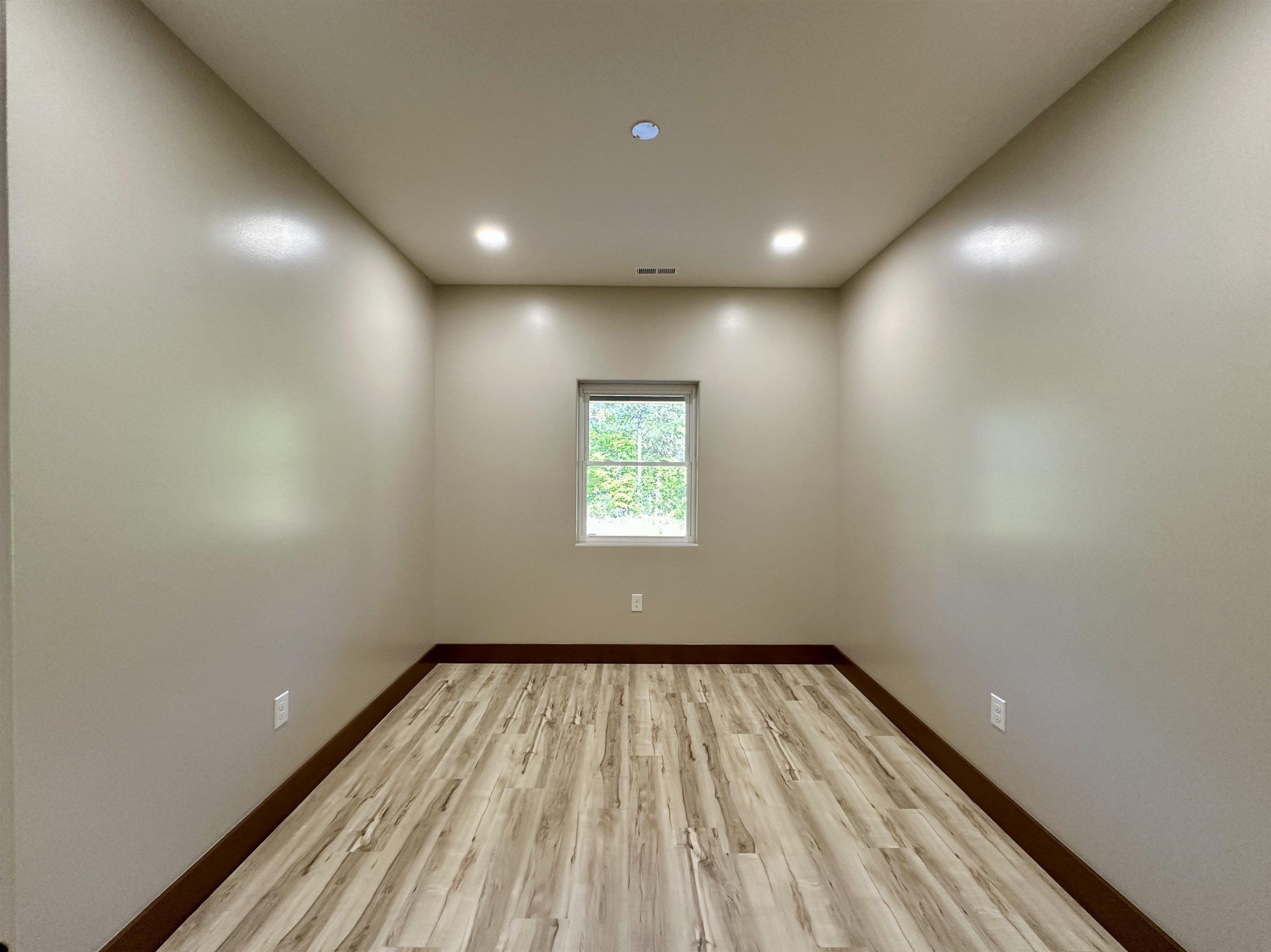 1137 Arl Bailey Road Finger, TN 38334 - Photo 16 of 40 a view of empty room with wooden floor and fan