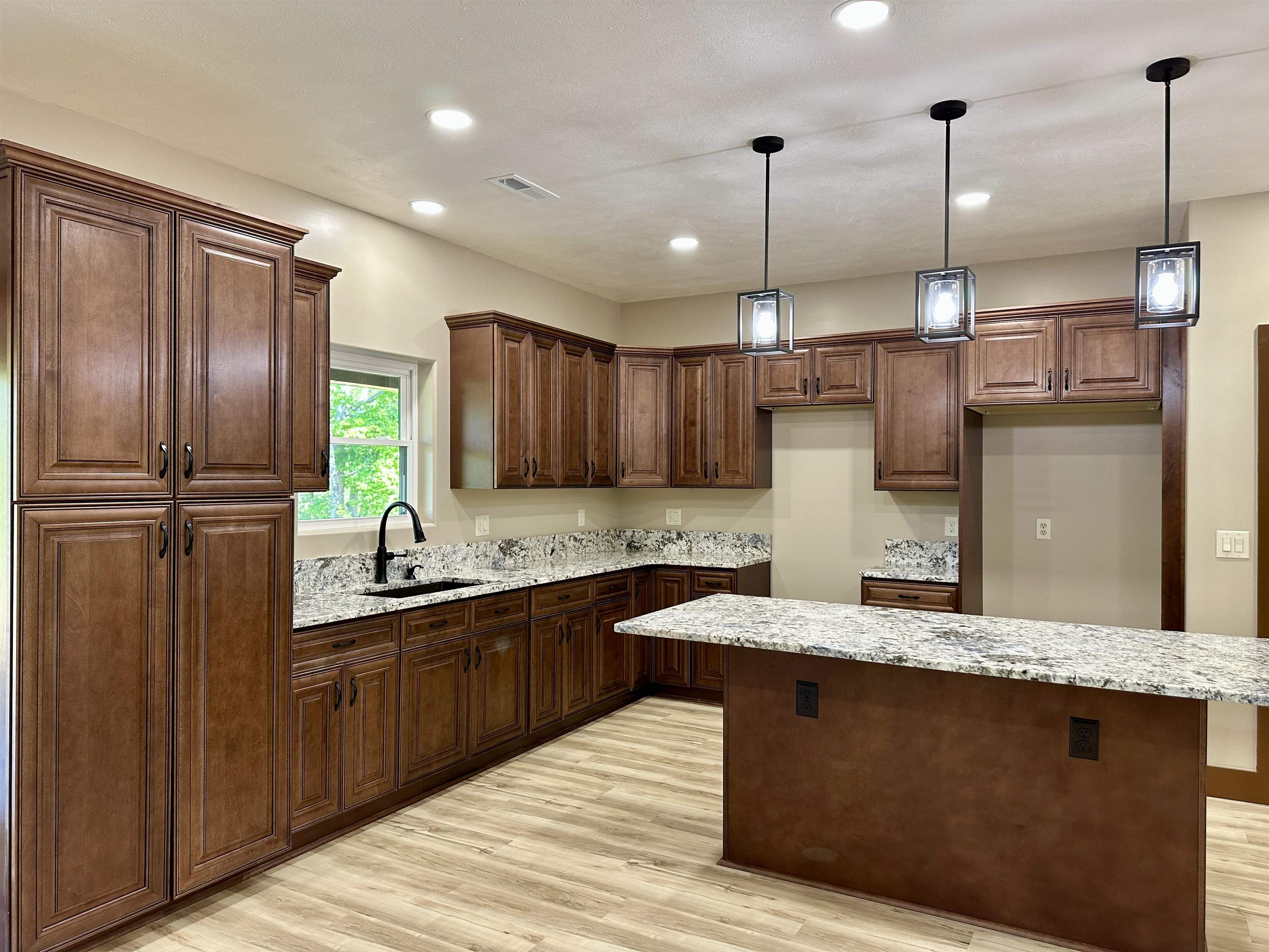 1137 Arl Bailey Road Finger, TN 38334 - Photo 6 of 40 a kitchen with kitchen island granite countertop a sink stainless steel appliances and cabinets