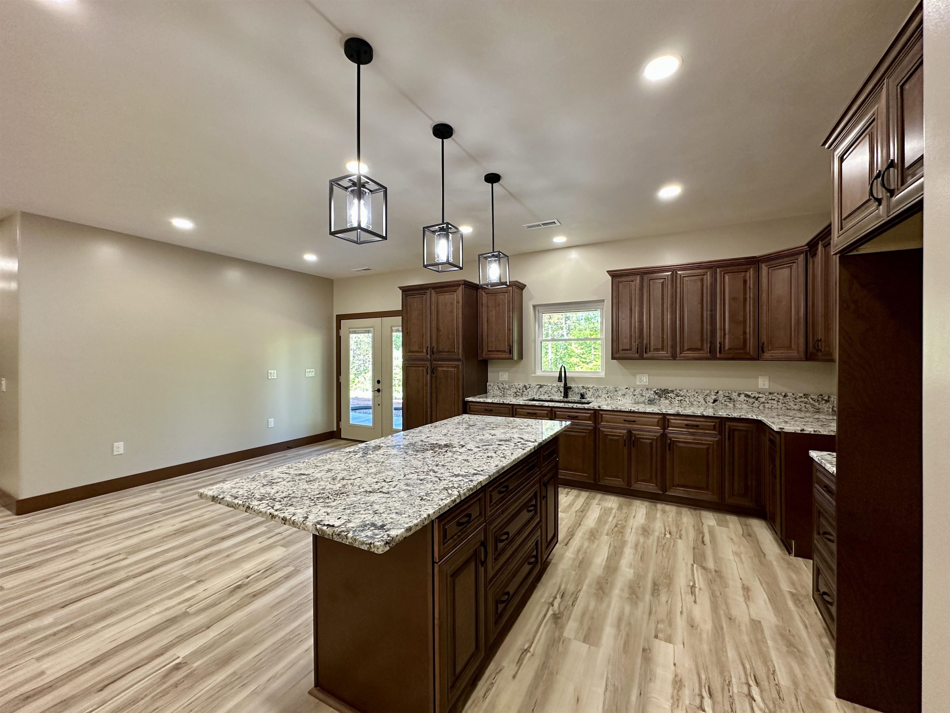 1137 Arl Bailey Road Finger, TN 38334 - Photo 7 of 40 a kitchen with granite countertop kitchen island wooden cabinets and stainless steel appliances