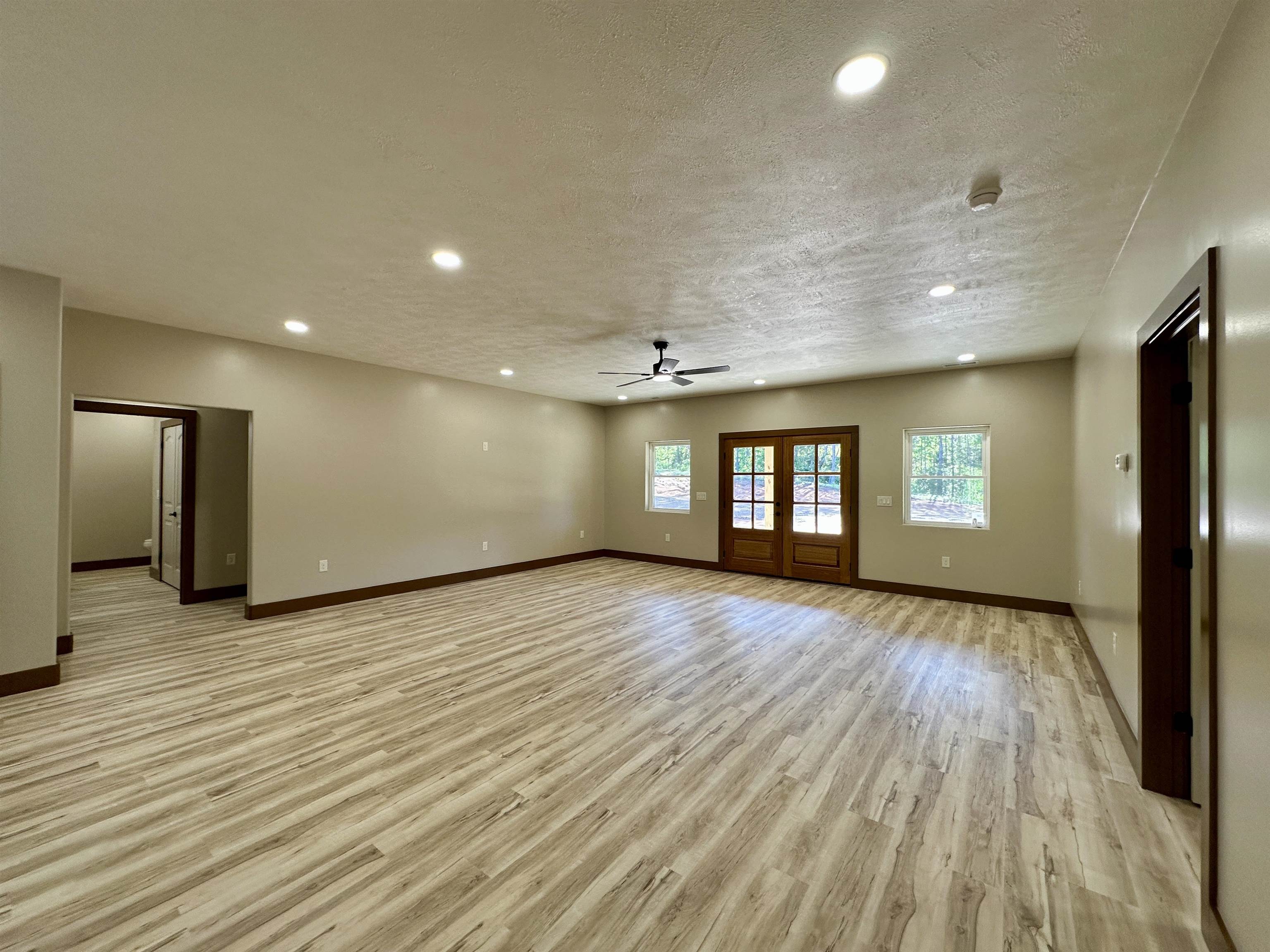 1137 Arl Bailey Road Finger, TN 38334 - Photo 8 of 40 a view of an empty room with window and wooden floor