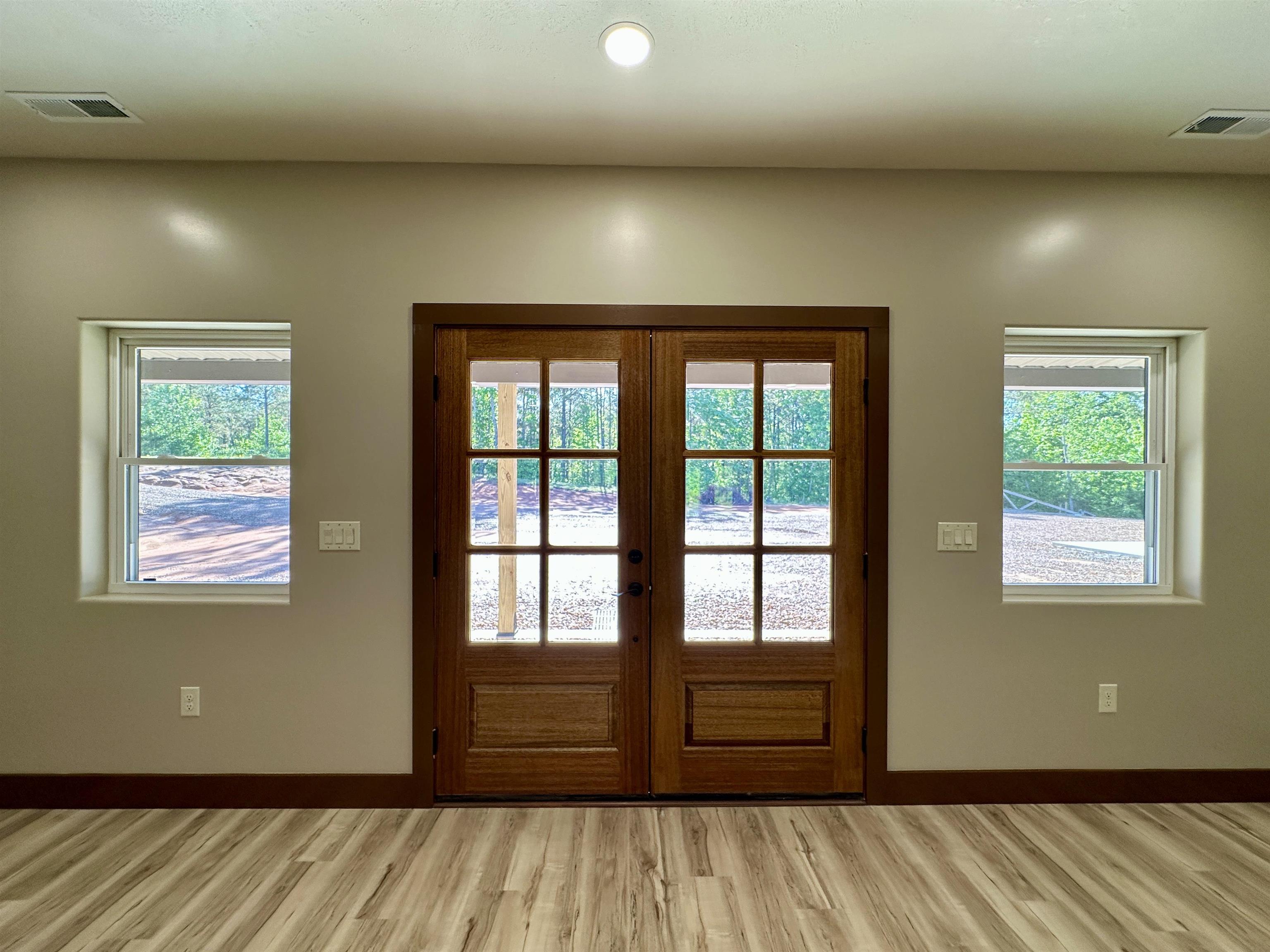 1137 Arl Bailey Road Finger, TN 38334 - Photo 9 of 40 an empty room with wooden floor and windows