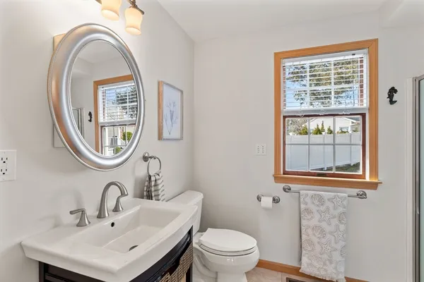 a bathroom with a toilet a sink and a window