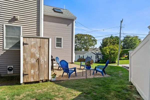 a view of a chair and table in front of a house