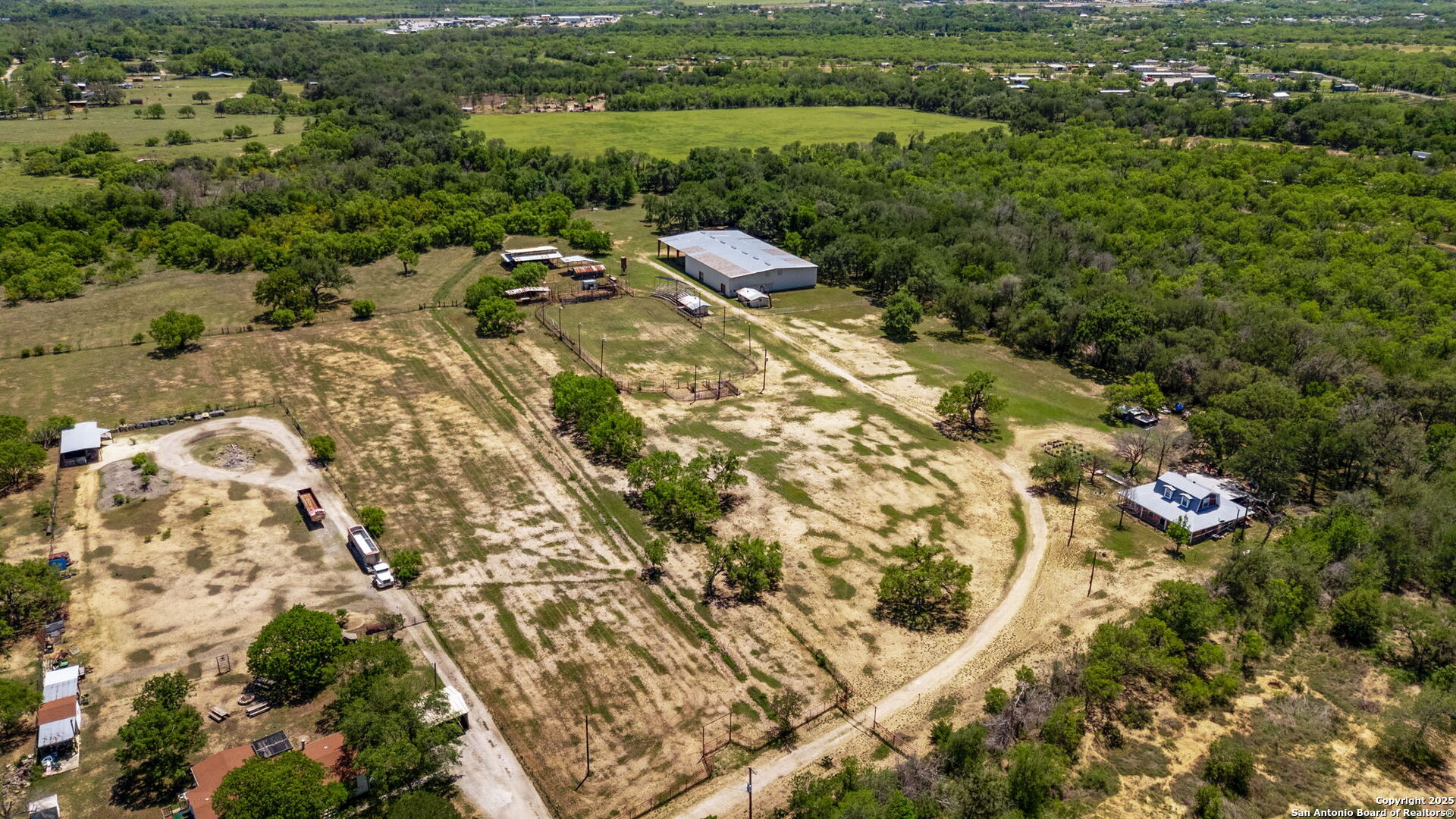 11224 Atkins Road Atascosa, TX 78002 - Photo 4 of 45 an aerial view of a house with a yard and lake view
