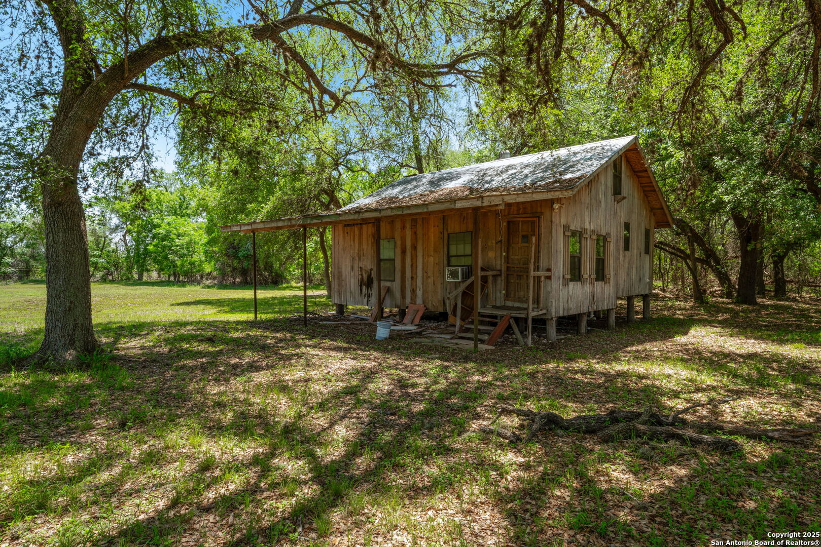 11224 Atkins Road Atascosa, TX 78002 - Photo 41 of 45 a view of a barn in the middle of a yard