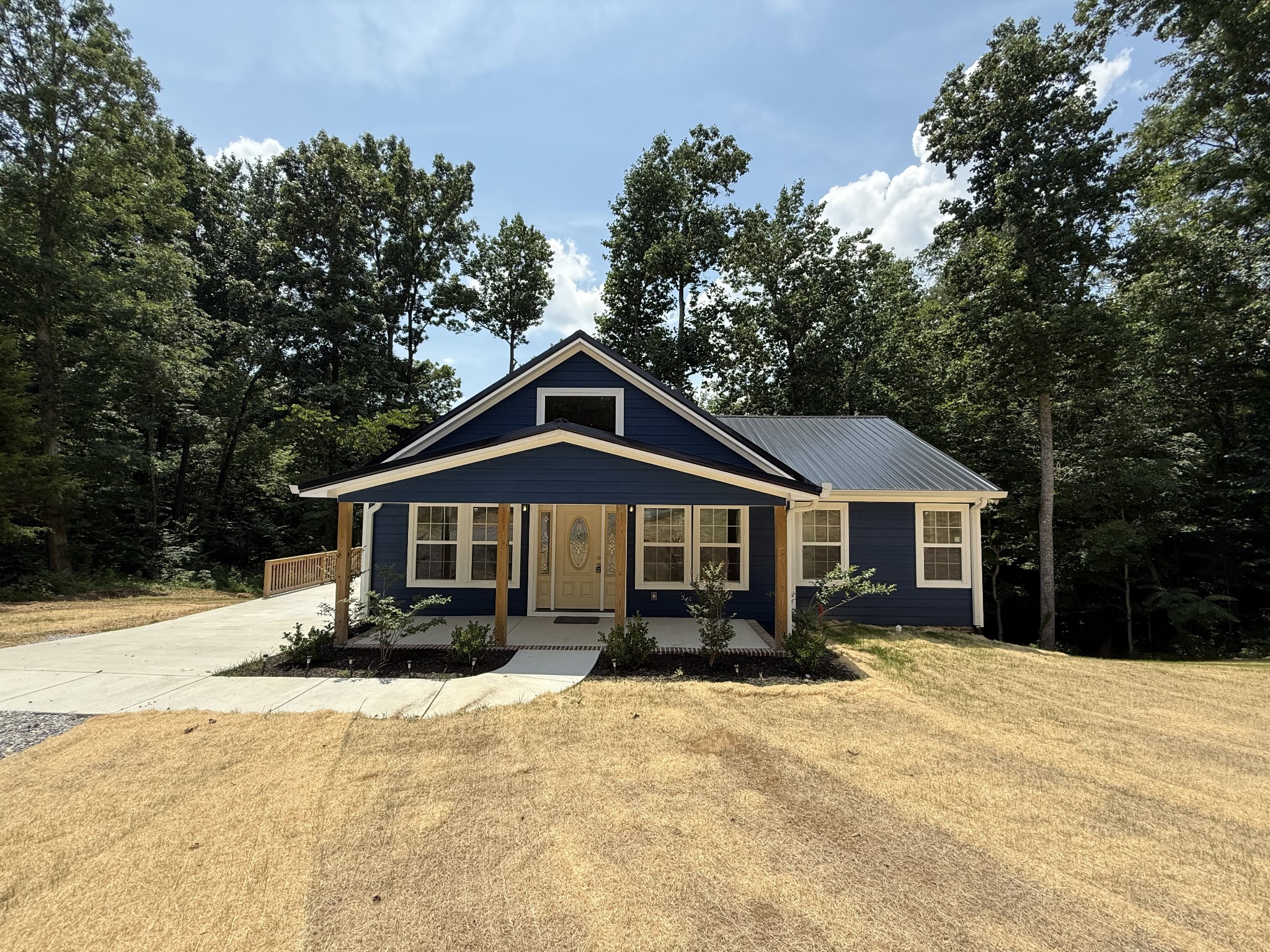 993 Throneberry Road Normandy, TN 37360 - Photo 1 of 56 a front view of a house with a yard covered in snow and trees