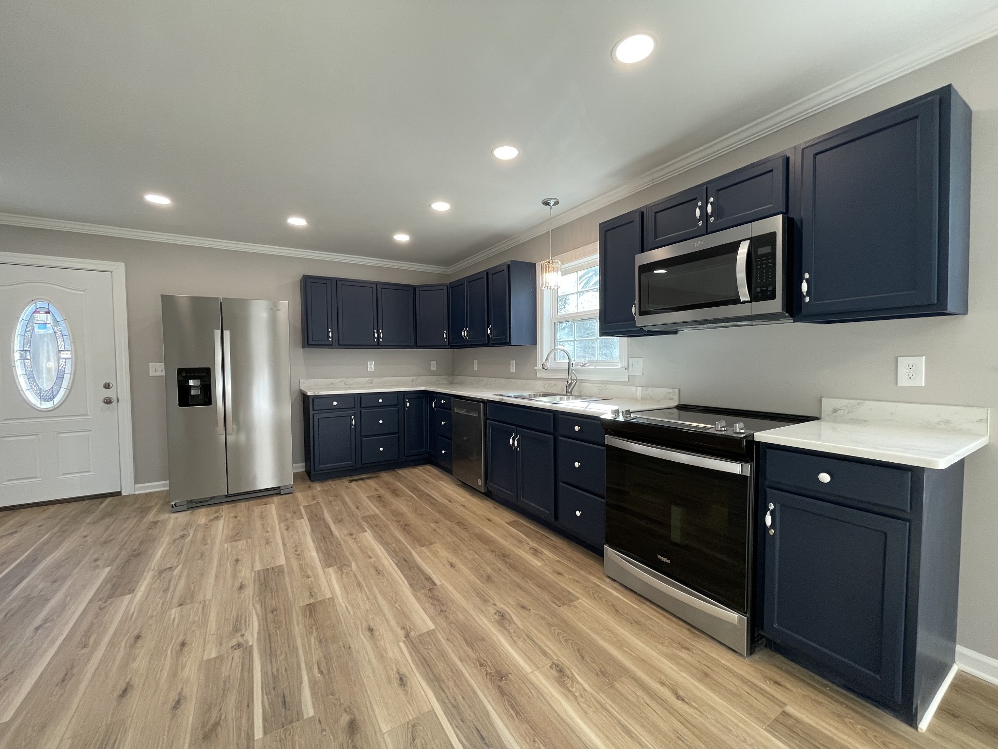 993 Throneberry Road Normandy, TN 37360 - Photo 24 of 56 a large kitchen with stainless steel appliances granite countertop a stove a sink dishwasher and a microwave with wooden floor