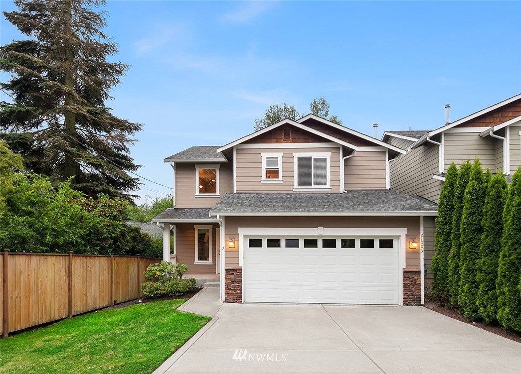 21006 42nd Avenue Southeast, Unit A Bothell, WA 98021 - Photo 1 of 19 a front view of a house with a yard and garage