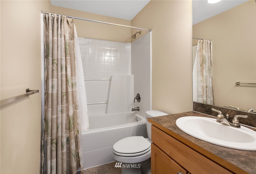 21006 42nd Avenue Southeast, Unit A Bothell, WA 98021 - Photo 16 of 19 a bathroom with a sink a toilet and a bathtub